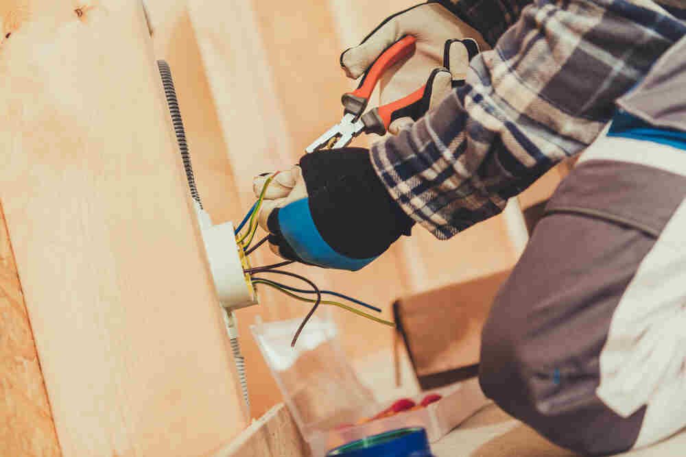 Male Electrician rewiring house. Blackhorse Electrical, London.